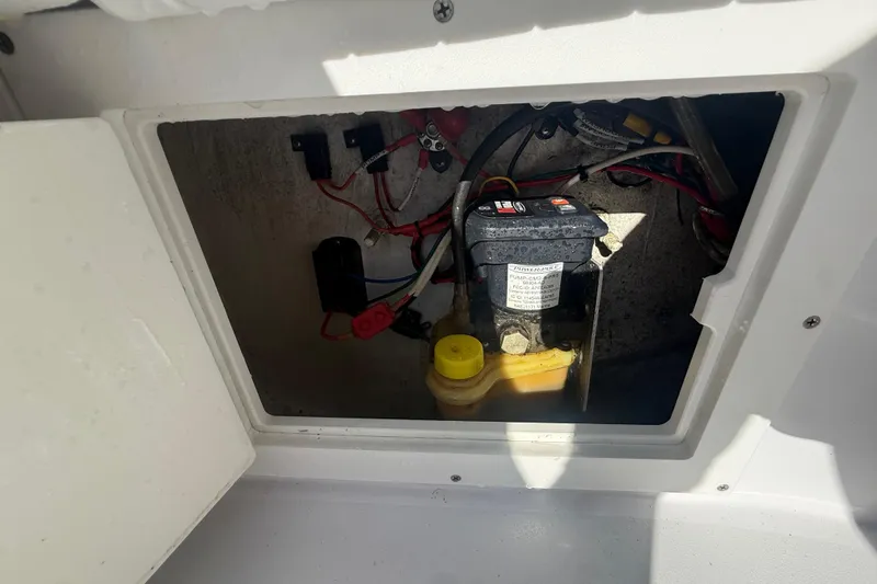 Slide: The Image of 1984 Chris-Craft 213 Scorpion boat compartment with wiring and pump system visible. - 71