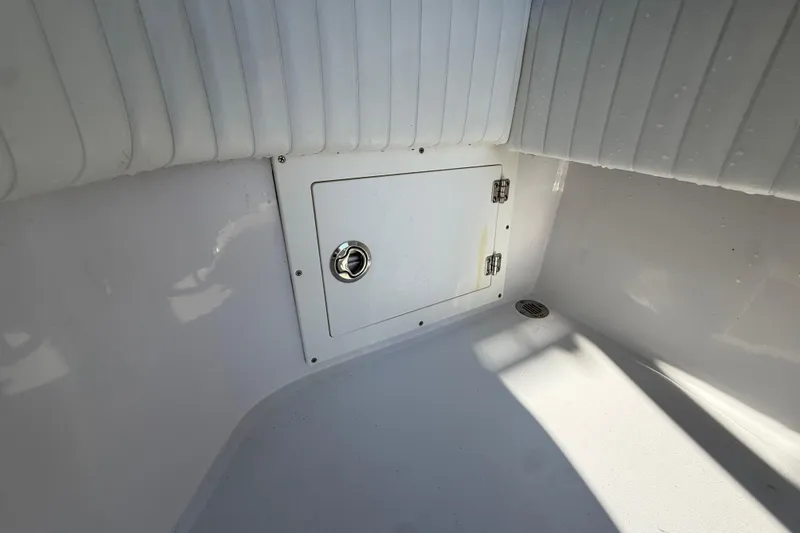 Slide: The Image of Interior view of a 1984 Chris-Craft 213 Scorpion boat, featuring a storage compartment. - 72