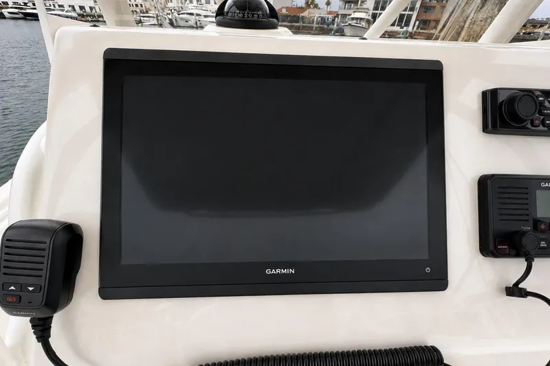 Slide: The Image of Garmin marine electronics on 2019 Edgewater 245CC boat dashboard, featuring a large display screen. - 11