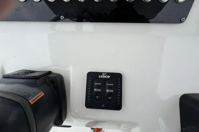 Slide: The Image of Control panel of a 2019 Edgewater 245CC boat with Lenco trim tab switches. - 8