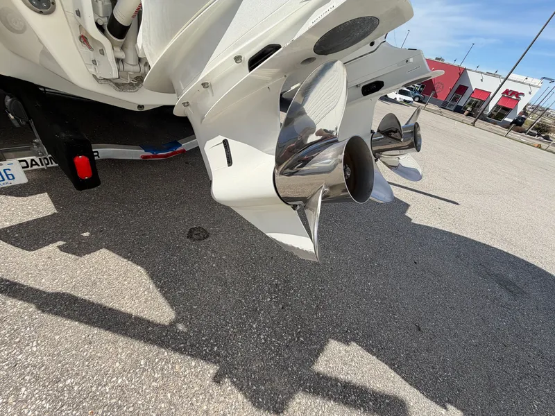 Slide: The Image of 2023 Cobalt R8 Outboard with shiny propellers on parking lot. - 20