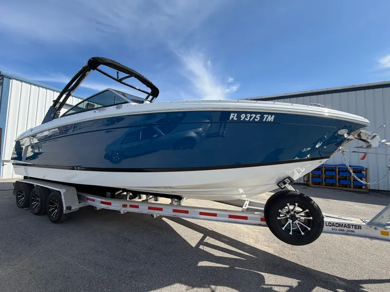 Slide: The Image of 2023 Cobalt R8 Outboard on trailer, blue hull, sunny day. - 4
