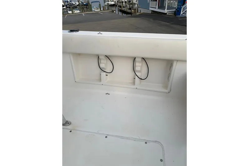 Slide: The Image of 2006 Sea Hunt Triton 220 boat interior, featuring storage compartments and clean white deck. - 10