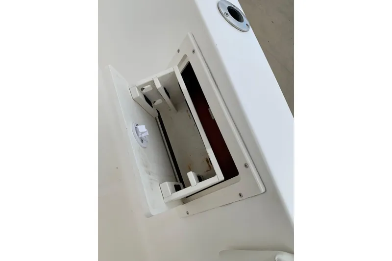 Slide: The Image of Open storage compartment on a 2006 Sea Hunt Triton 220 boat. - 11