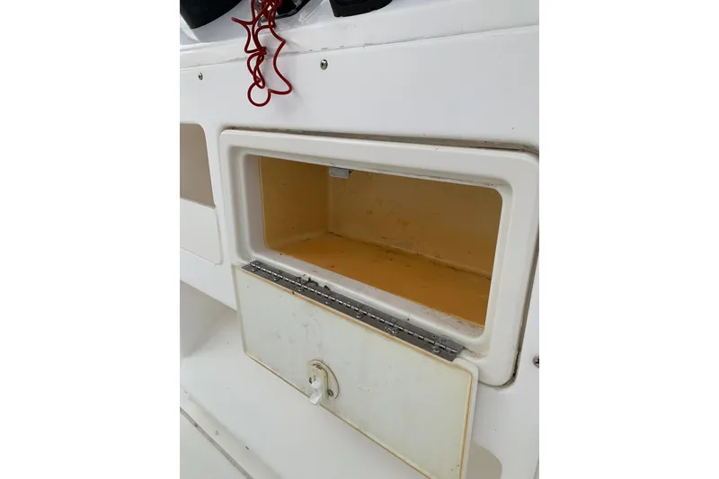 Slide: The Image of Open storage compartment on a 2006 Sea Hunt Triton 220 boat. - 17