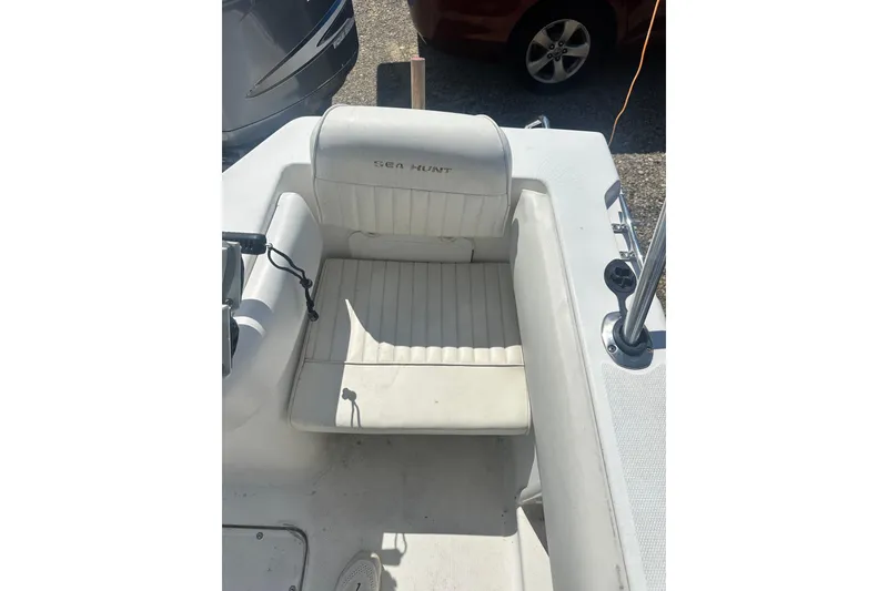 Slide: The Image of 2006 Sea Hunt Triton 220 boat seat, white upholstery, outdoor setting. - 21