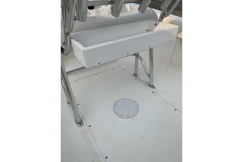 Slide: The Image of 2006 Sea Hunt Triton 220 boat interior with rod holders and storage compartment. - 22