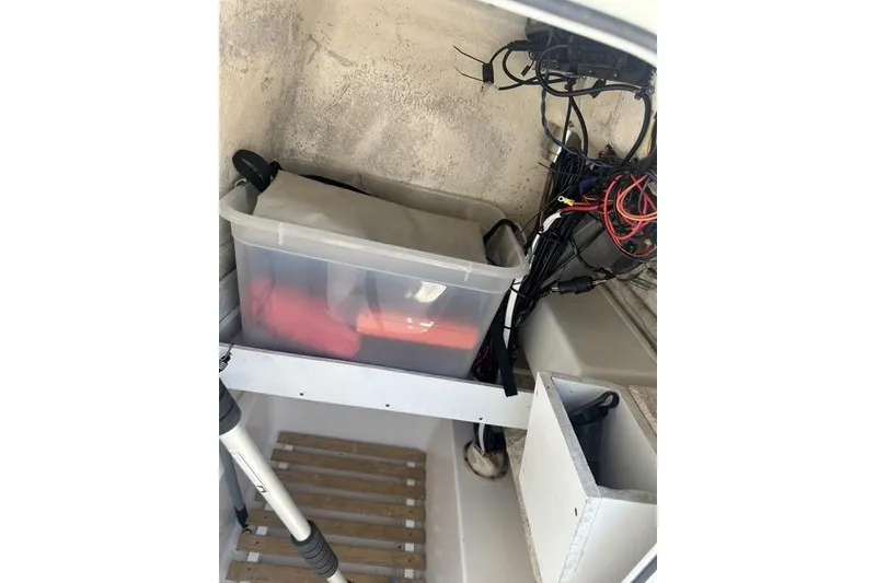 Slide: The Image of Interior storage of 2006 Sea Hunt Triton 220 boat with organized wiring and equipment. - 30