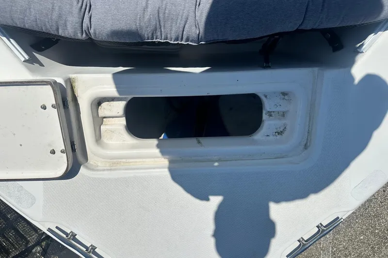 Slide: The Image of Open storage compartment on a 2006 Sea Hunt Triton 220 boat deck. - 31