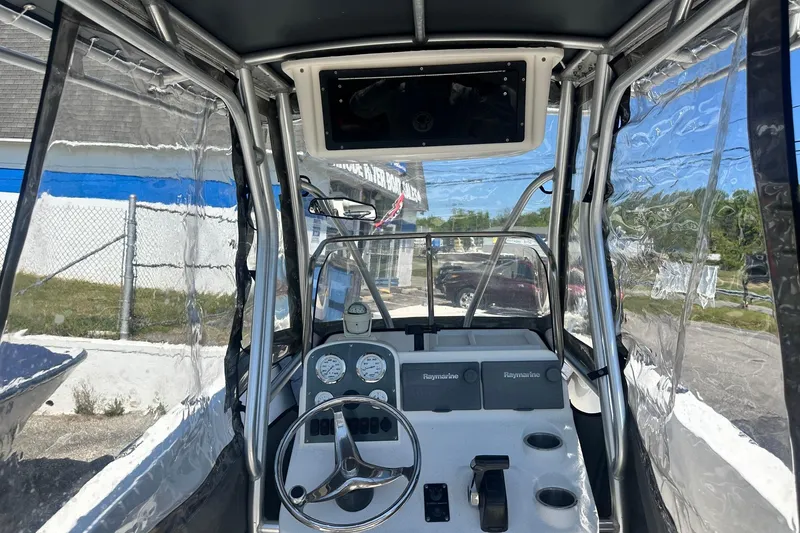 Slide: The Image of 2006 Sea Hunt Triton 220 boat cockpit with steering wheel and Raymarine electronics. - 32