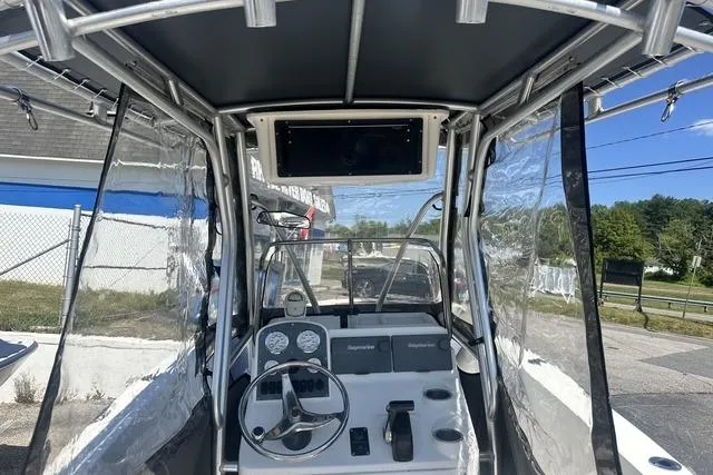 Slide: The Image of 2006 Sea Hunt Triton 220 boat cockpit with steering wheel and navigation instruments. - 35