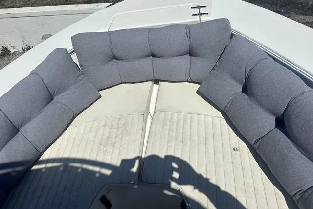 Slide: The Image of 2006 Sea Hunt Triton 220 boat with cushioned seating in the bow area. - 41