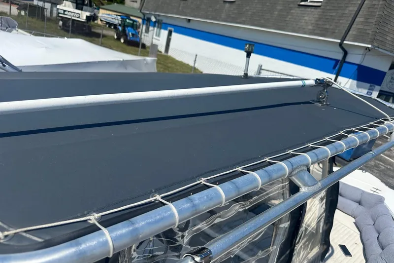 Slide: The Image of 2006 Sea Hunt Triton 220 boat with a sturdy metal frame and protective canopy. - 43