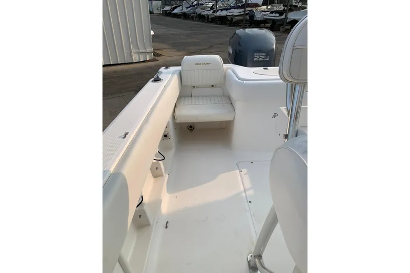 Slide: The Image of 2006 Sea Hunt Triton 220 boat interior with Yamaha 225 engine, docked outdoors. - 5