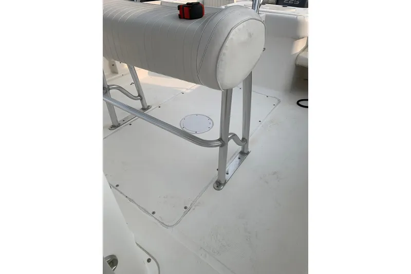 Slide: The Image of 2006 Sea Hunt Triton 220 boat interior with white seating and metal frame. - 9