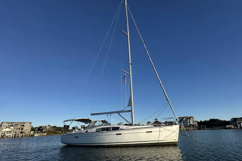Slide: The Image of 2009 Beneteau Oceanis 40 sailboat on calm water with clear blue sky. - 1