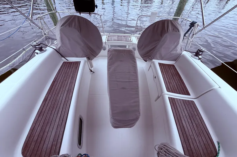 Slide: The Image of Cockpit of 2009 Beneteau Oceanis 40 sailboat with covered steering wheels and wooden seating. - 15