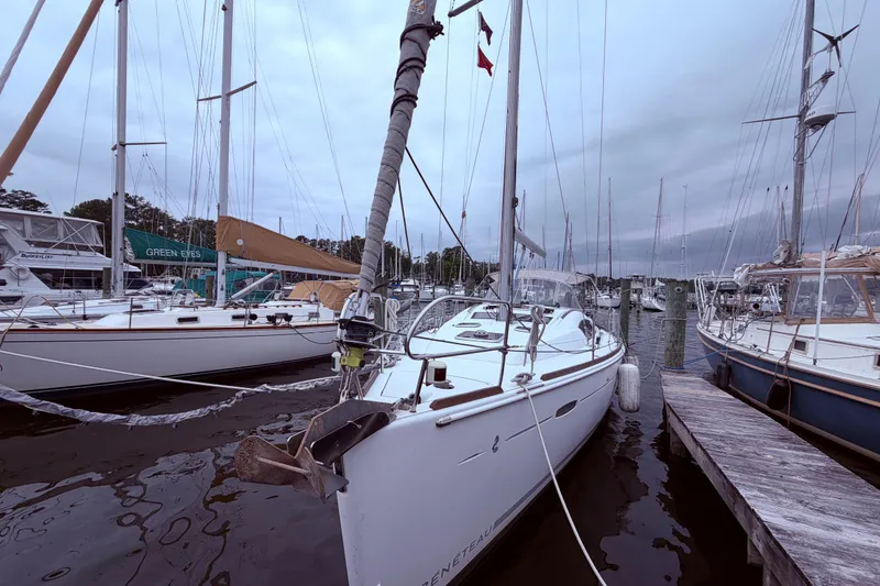 Slide: The Image of 2009 Beneteau Oceanis 40 sailboat docked at a marina under cloudy skies. - 3