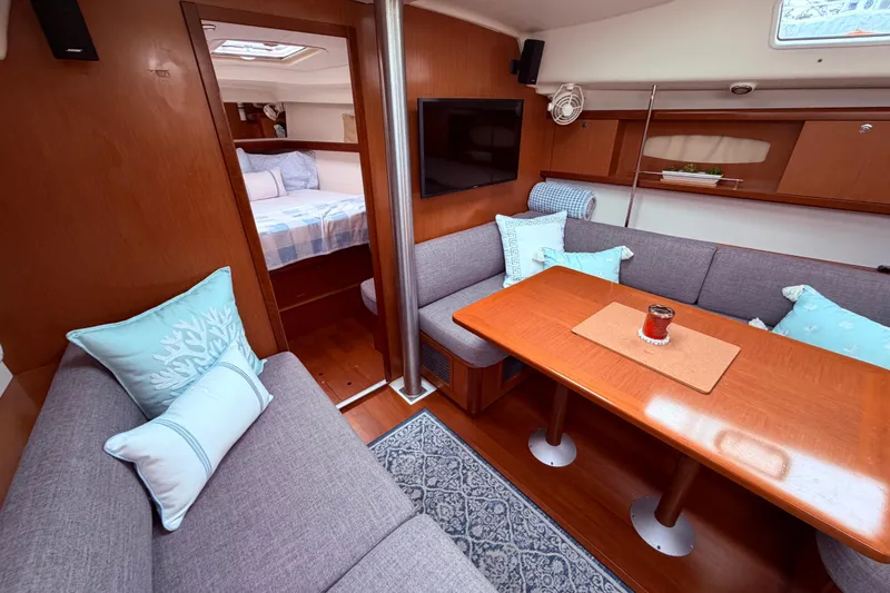 Slide: The Image of Interior of 2009 Beneteau Oceanis 40 yacht, featuring wooden cabinetry and compact kitchen area. view from the dinette area looking to companionway - 46