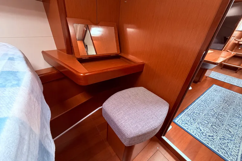 Slide: The Image of Interior of 2009 Beneteau Oceanis 40 yacht with cozy seating and wooden table. - 49