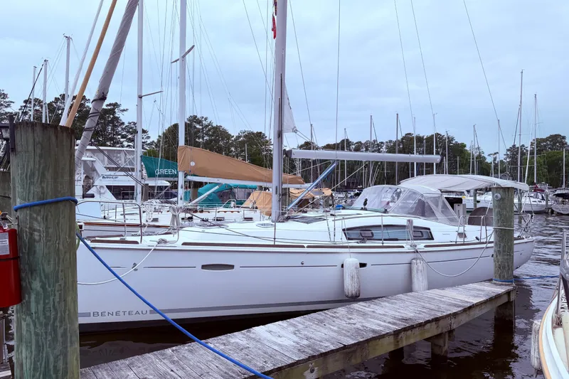 Slide: The Image of 2009 Beneteau Oceanis 40 sailboat docked at a marina with other boats. - 6