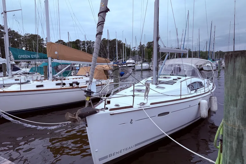 Slide: The Image of 2009 Beneteau Oceanis 40 sailboat docked in a marina, surrounded by other boats. - 7