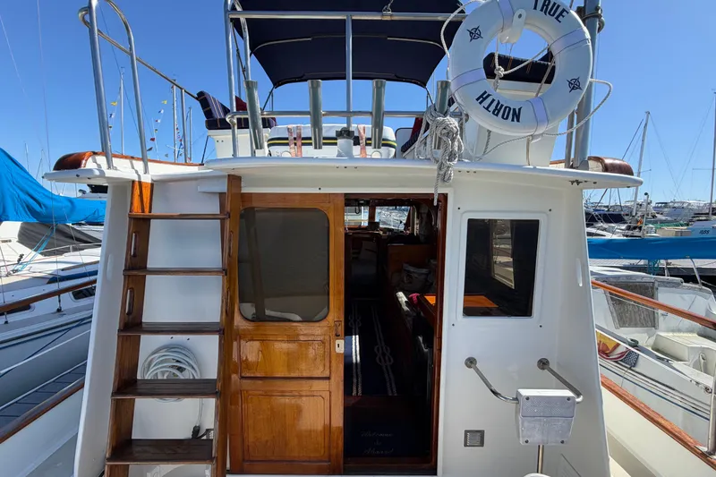 Slide: The Image of 1982 Lien Hwa 31 yacht with wooden accents and lifebuoy, docked at marina. - 12