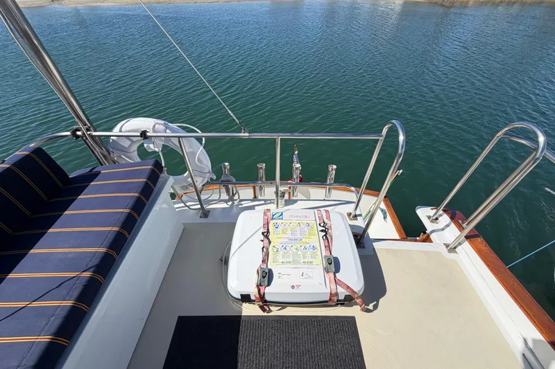 Slide: The Image of 1982 Lien Hwa 31 boat deck with seating and safety equipment, overlooking calm water. - 14