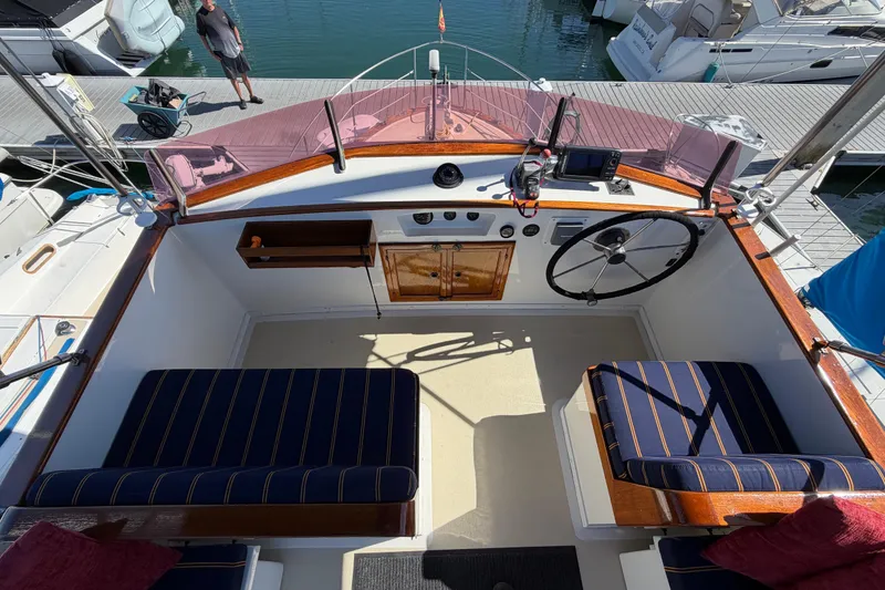 Slide: The Image of Cockpit of a 1982 Lien Hwa 31 boat with striped seating and wooden accents. - 17