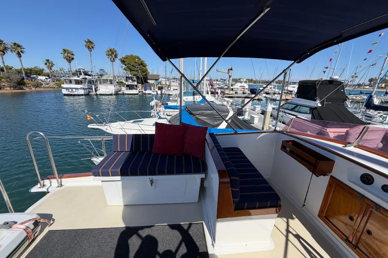 Slide: The Image of 1982 Lien Hwa 31 yacht deck with seating, docked in a sunny marina. - 18