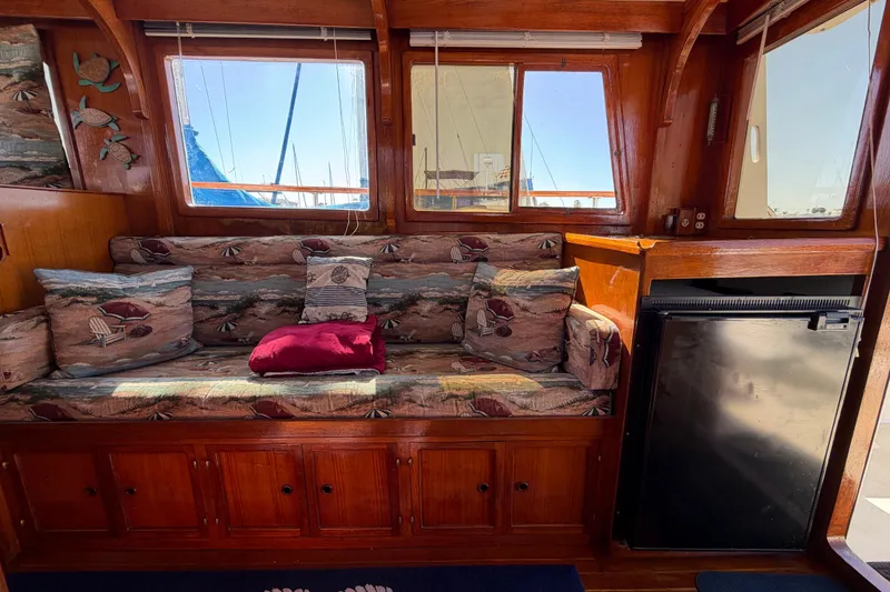 Slide: The Image of 1982 Lien Hwa 31 yacht interior with cushioned seating and wooden cabinetry. - 33