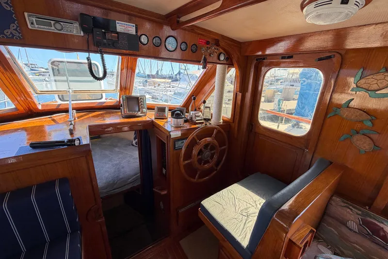 Slide: The Image of Interior of 1982 Lien Hwa 31 boat with wooden helm and nautical decor. - 34