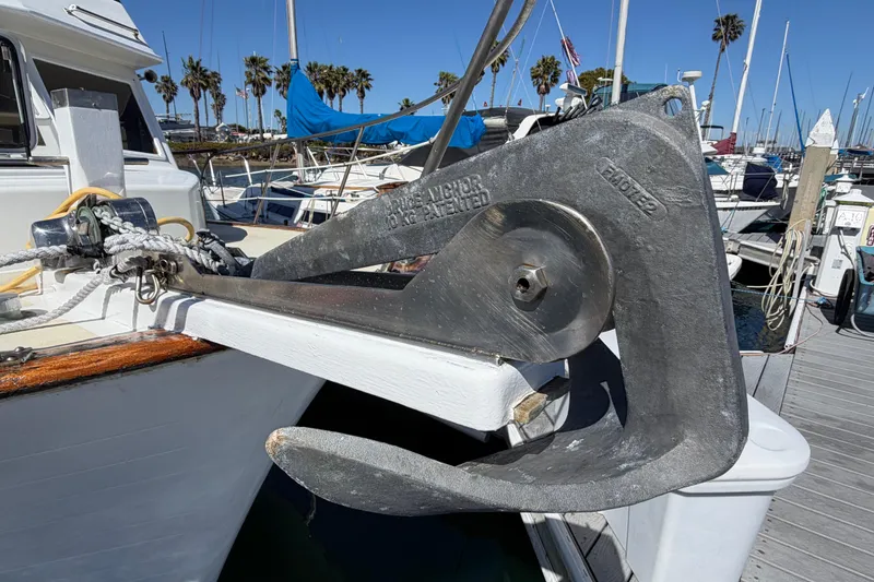 Slide: The Image of Anchor on 1982 Lien Hwa 31 boat, docked at marina with palm trees. - 4