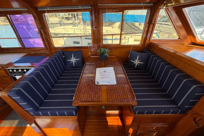 Slide: The Image of Interior of 1982 Lien Hwa 31 yacht with striped seating and wooden table. - 40