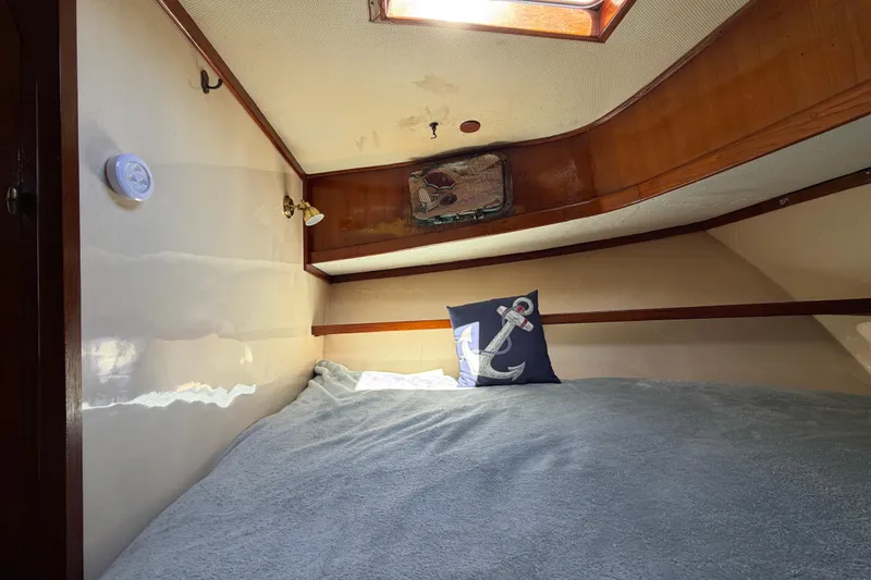 Slide: The Image of Cozy cabin interior of 1982 Lien Hwa 31 boat with anchor-themed pillow. - 45