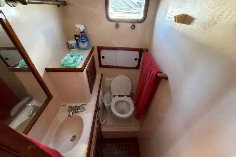 Slide: The Image of Compact bathroom in 1982 Lien Hwa 31 boat with sink, toilet, and cleaning supplies. - 48