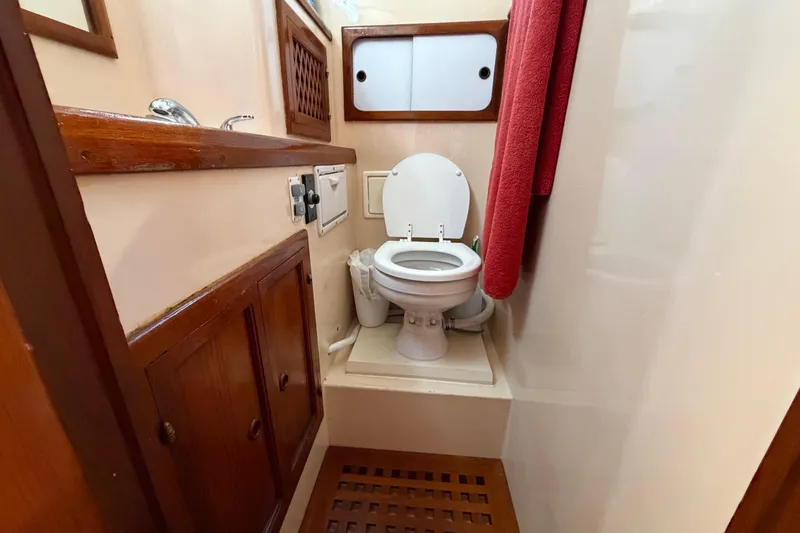 Slide: The Image of 1982 Lien Hwa 31 yacht bathroom with wooden cabinets and white toilet. - 50