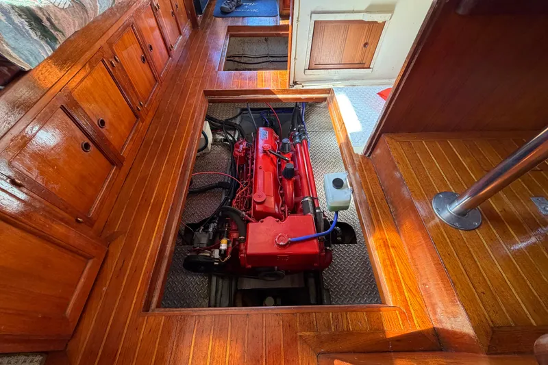 Slide: The Image of 1982 Lien Hwa 31 boat engine compartment with polished wood flooring and red engine. - 51