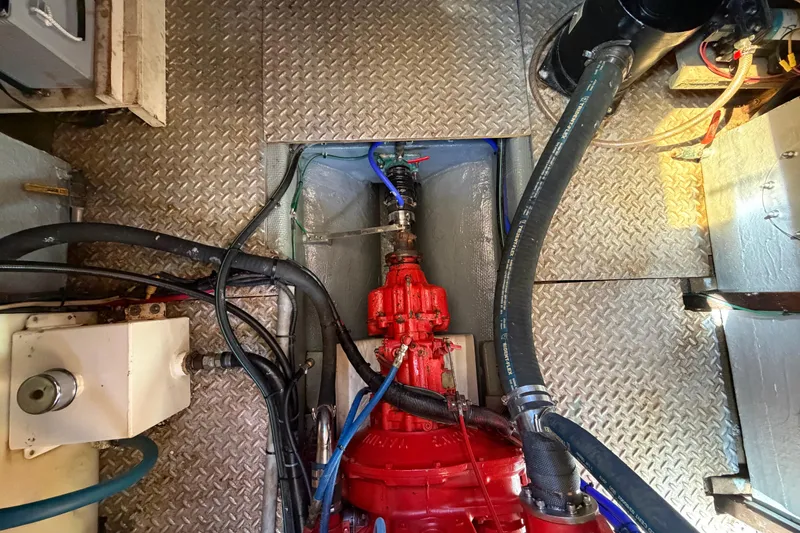 Slide: The Image of Engine room of 1982 Lien Hwa 31 boat with visible red machinery and hoses. - 52