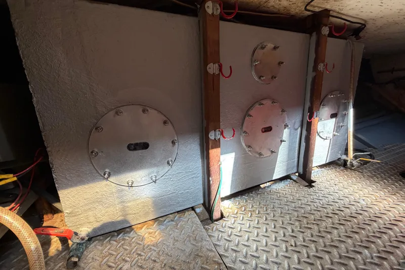 Slide: The Image of Engine room of 1982 Lien Hwa 31 boat with metal tanks and diamond plate flooring. - 54