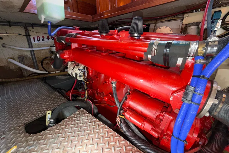 Slide: The Image of Engine room of a 1982 Lien Hwa 31 boat with red machinery and blue hoses. - 57