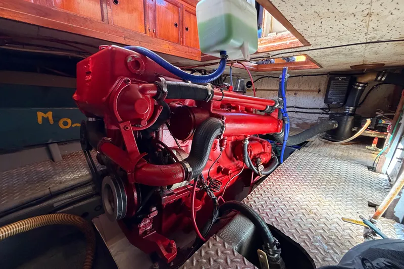 Slide: The Image of Red engine inside a 1982 Lien Hwa 31 boat, showcasing mechanical components and piping. - 59