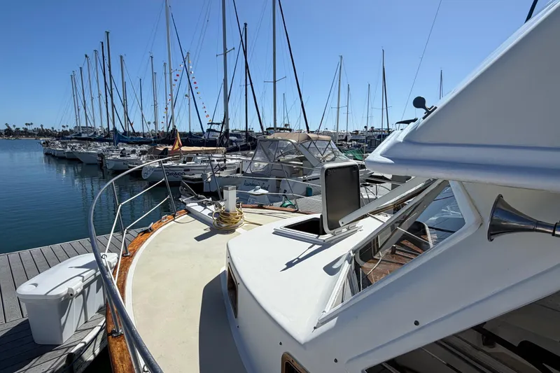 Slide: The Image of 1982 Lien Hwa 31 yacht docked in a marina with sailboats in the background. - 6