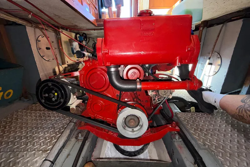 Slide: The Image of Red engine inside a 1982 Lien Hwa 31 boat, showcasing mechanical components and belts. - 60