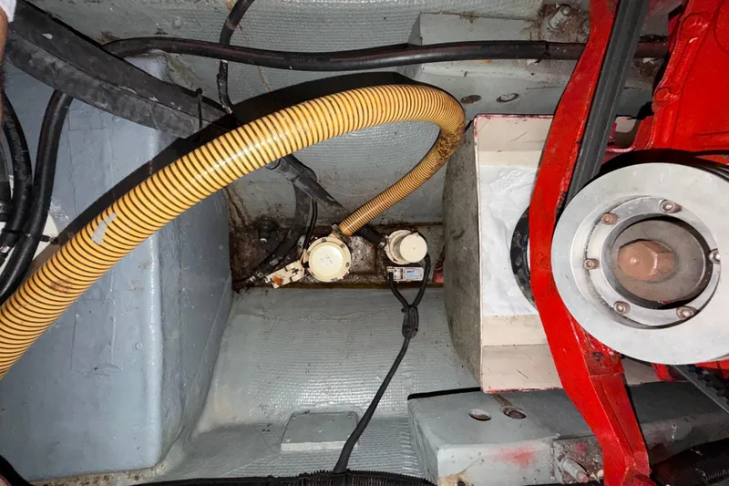 Slide: The Image of Engine compartment of a 1982 Lien Hwa 31 boat, featuring hoses and mechanical components. - 61