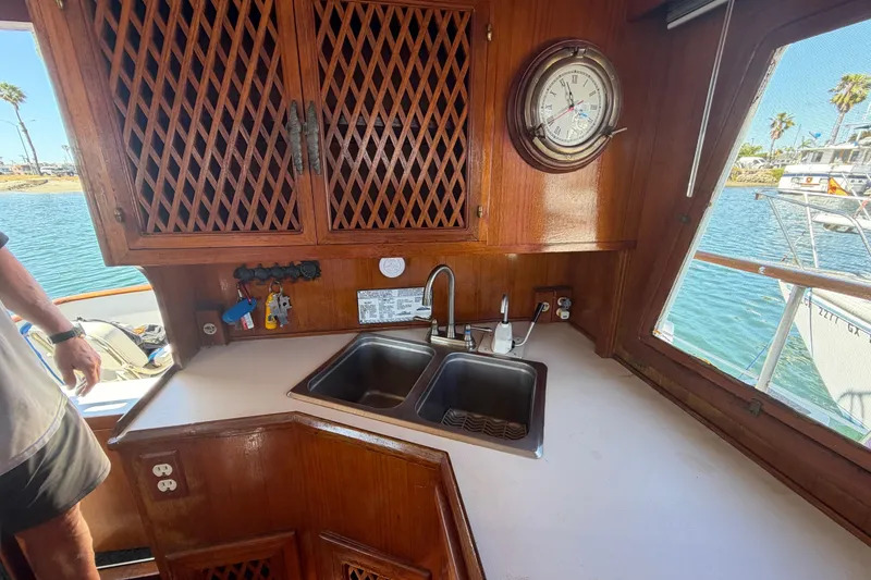 Slide: The Image of 1982 Lien Hwa 31 yacht interior with wooden cabinetry, sink, and nautical decor. - 66