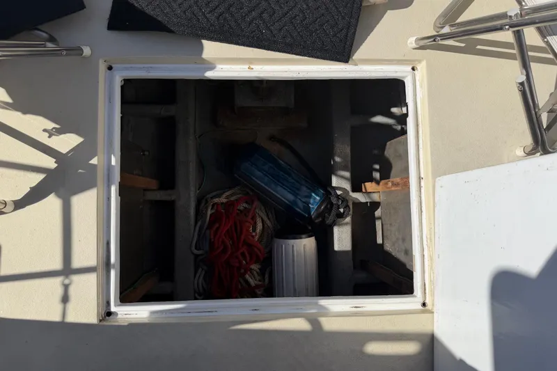 Slide: The Image of Open hatch on 1982 Lien Hwa 31 boat, showing storage with ropes and equipment. - 67