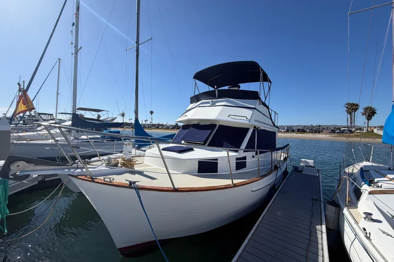 Slide: The Image of 1982 Lien Hwa 31 yacht docked at marina under clear blue sky. - 73