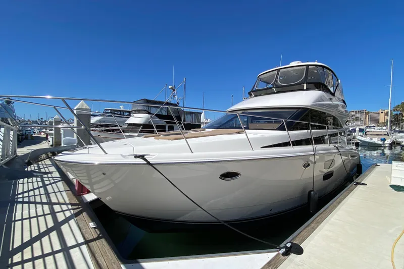 The Image of Luxury 2011 Meridian 441 Sedan yacht docked at marina under clear blue sky. - 1