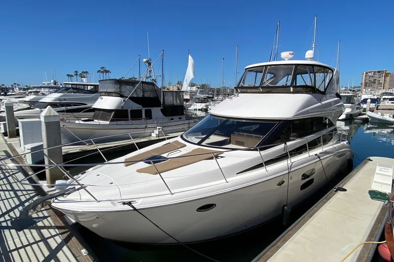 Slide: The Image of 2011 Meridian 441 Sedan yacht docked at marina under clear blue sky. - 3